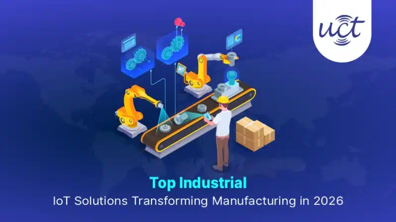 Technician using a tablet to monitor robotic arms and assembly line data, highlighting key industrial IoT solutions in manufacturing.